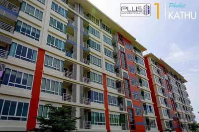 a large apartment building with red and white windows at A Stylish Condo in Local Area Kathu, Phuket in Kathu