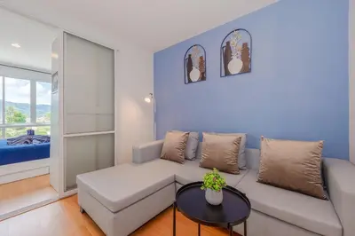 a living room with a couch and a table at A Nice Condo in Local Livelyhood of Kathu in Kathu