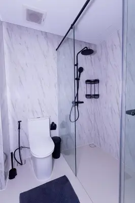 a white bathroom with a shower and a toilet at апартаменты с двумя спальнями in Karon Beach