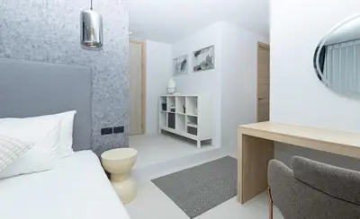 a bedroom with a bed and a desk and a chair at апартаменты с двумя спальнями in Karon Beach