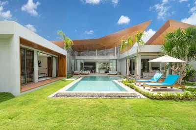 an exterior view of a house with a swimming pool at Zenithy Morden Pool and Garden Villa near Bangtao Beach in Ban Pak Lak