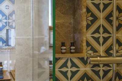 a bathroom with two bottles of essential oils on a wall at The Ozone Lounge Lovers Golf View Bangtao in Laguna Phuket