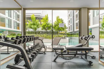 a gym with cardio equipment in a building at The Ozone Catisse Golf View Bangtao in Laguna Phuket