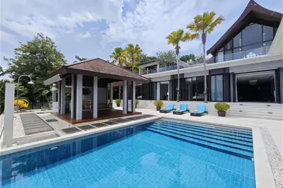 an exterior view of a house with a swimming pool at Villa Elegance Luxury Ocean View Pool Villa with Breakfas & Daily Maid Service in Ko Lek