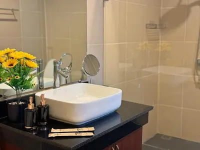 a white sink on a counter in a bathroom at shine bright villa in Ban Saiyuan (1)