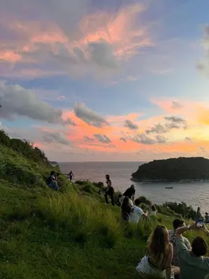 a group of people sitting on a hill watching the sunset at shine bright villa in Ban Saiyuan (1)