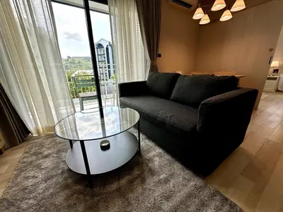 a living room with a couch and a glass table at Beatiful titlhalo apartment in Nai Yang Beach