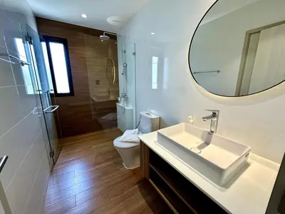 a bathroom with a sink and a mirror and a toilet at Beatiful titlhalo apartment in Nai Yang Beach