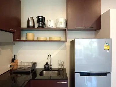 a kitchen with a sink and a refrigerator at A Well Equipped Condo near Karon Beach in Karon Beach