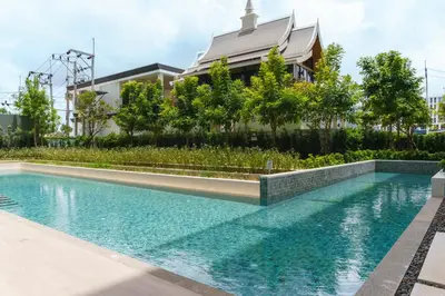 a swimming pool in front of a building at The Ozone Scarlet Grey Golf View Bangtao in Laguna Phuket
