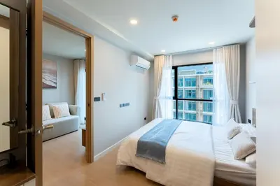 a bedroom with a large bed and a window at RJ Space in Ban Thalat Choeng Thale