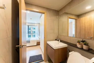 a bathroom with a sink and a mirror at RJ Space in Ban Thalat Choeng Thale