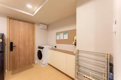 a laundry room with a washer and dryer at RJ Space in Ban Thalat Choeng Thale