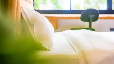 a bed with a pillow and a chair in a room at Quiet & Comfy studio - Walk to Rawai Beach - 