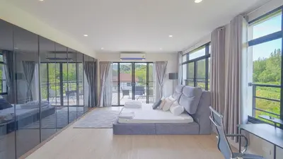 a living room with a couch and some windows at 5BR Lucky Pool Villa Kathu Golf - 12 guest in Kathu