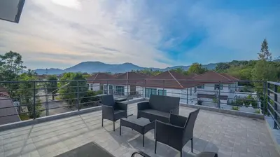 a patio with chairs and a table on a balcony at 5BR Lucky Pool Villa Kathu Golf - 12 guest in Kathu