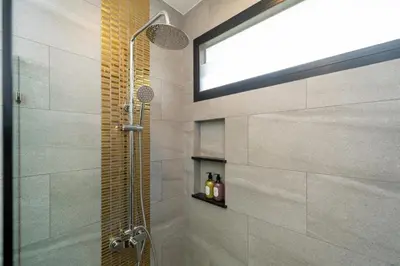 a bathroom with a shower with a glass door at DC Resident Phuket in Phuket Town