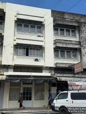 two people walking in front of a building at bége in Ban Lo Long