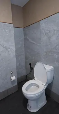 a bathroom with a white toilet in a room at Salty Pearl Phuket 2 in Patong Beach