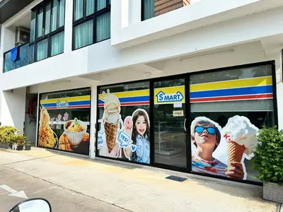 a store window with ice cream advertisements on it at Condominium Royal Lee Airport Phuket30 in Ban Bo Han