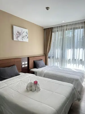a hotel room with two beds with a stuffed animal on them at Condominium Royal Lee Airport Phuket30 in Ban Bo Han