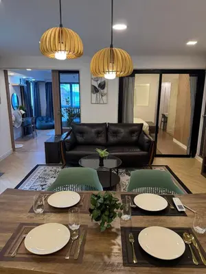 a living room with a table and a couch at Rinda House Patong 31 in Patong Beach