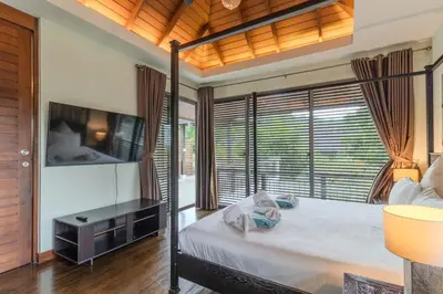 a bedroom with a bed and a large window at V241 3BR Peaceful Pool Villa, Garden & Jacuzzi in Koh Lone