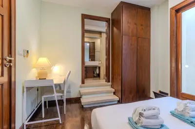 a bedroom with a bed and a desk with a lamp at V241 3BR Peaceful Pool Villa, Garden & Jacuzzi in Koh Lone