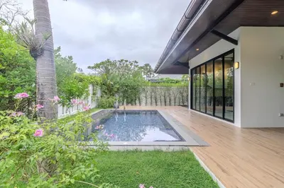 an external view of a house with a swimming pool at V242 Prime Location 2BR with Pool&Garden Near Beach in Bang Tao Beach