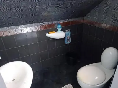 a bathroom with a white toilet and a sink at Villa Rawai Pool 3 Room in Ban Saiyuan (1)