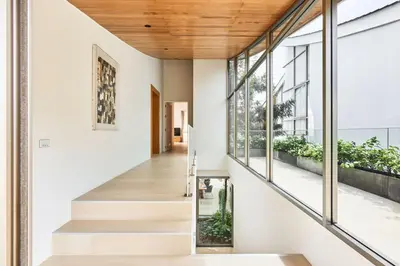 a staircase leading to the second floor of a house at Trinity 4 BDR POOL Villa in Ban Pak Lak