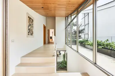 a staircase leading to the second floor of a house at Trinity 4 BDR POOL Villa in Ban Pak Lak