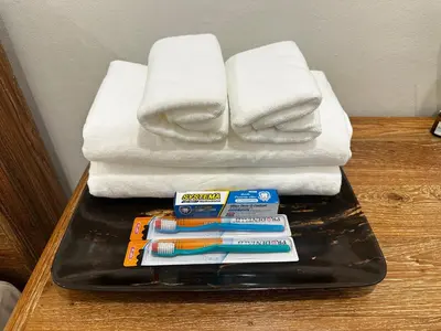 a tray with toothbrushes and towels on a table at House No 21-77 Near bangtao beach Phuket in Koh Lone