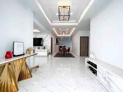 a large living room with white marble floors and a ceiling at Modern House in Phuket Town in Ban Na Khua