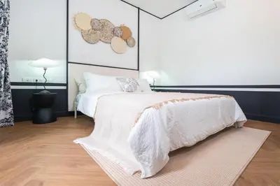 a bedroom with a bed with a white comforter at MONO Villa Bang Tao 3 bedroom modern pool villa in Ban Pak Lak