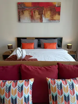 a bedroom with a large bed with red pillows at A Big Condo in Karon Walking distance to Beach in Karon Beach
