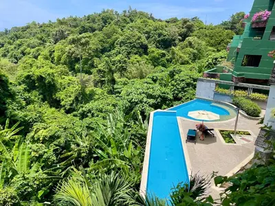 an aerial view of a resort with a swimming pool at Kata Eden View - 1 BR Beachfront Luxury Apartment in Karon Beach