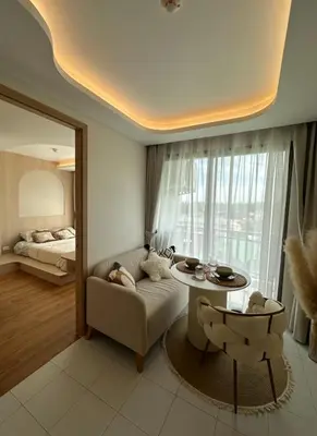 a living room with a couch and a table at Fantasea Condo Kamala in Kamala Beach