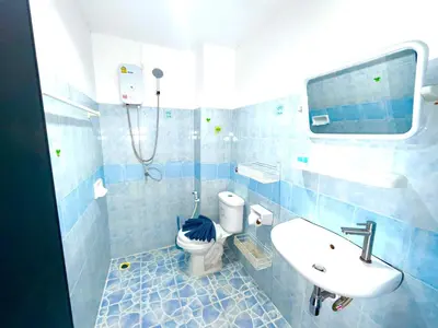 a blue tiled bathroom with a toilet and a sink at Patong Canal Villa 302 in Patong Beach