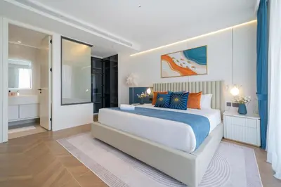 a white bedroom with a large bed and a bathroom at Sunshine Beach Luxury 3-bedrooms with a great view in Layan Beach