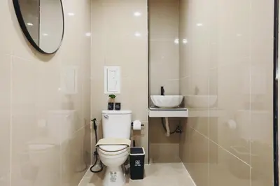 a bathroom with a toilet and a sink and a mirror at Wink Hill 1 Penthouse Patong 4 Bedrooms in Patong Beach