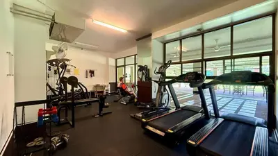 a gym with treadmills and machines in a room at Palace - Spacious 1 bedroom Condo with shared Pool in Patong Beach