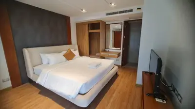 a bedroom with a bed and a flat screen tv at Penthouse 3 bedrooms with sea view and pool - Privilege residence in Patong Beach