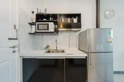 a small kitchen with a sink and a microwave at C237 Brand New 1BR Condo Pool Gym Near Beach in Bang Tao Beach