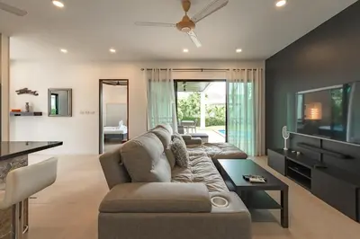 a living room with a couch and a tv at V246 Spacious 4BR Near Pier Private Pool & Garden in Rawai Beach