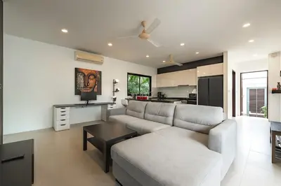 a living room with a couch and a table at V246 Spacious 4BR Near Pier Private Pool & Garden in Rawai Beach