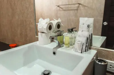 a bathroom sink with a roll of toilet paper on it at V246 Spacious 4BR Near Pier Private Pool & Garden in Rawai Beach