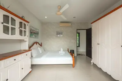 a bedroom with a bed and a ceiling fan at V246 Spacious 4BR Near Pier Private Pool & Garden in Rawai Beach
