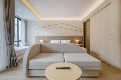 a hotel room with a couch and a bed at Pool View Condo 2204 Wyndham Garden Resort in Phuket Town