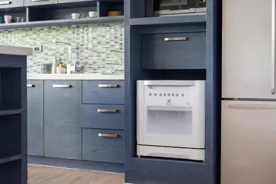 a kitchen with blue cabinets and a white oven at Designer Loft Villa Retreat in Pasak, Laguna Area in Ban Pak Lak